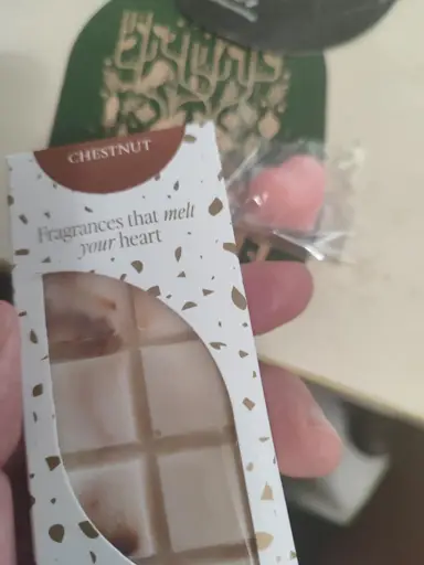 White Chestnut wax melt packaging with a window revealing the embossed wax bar inside.