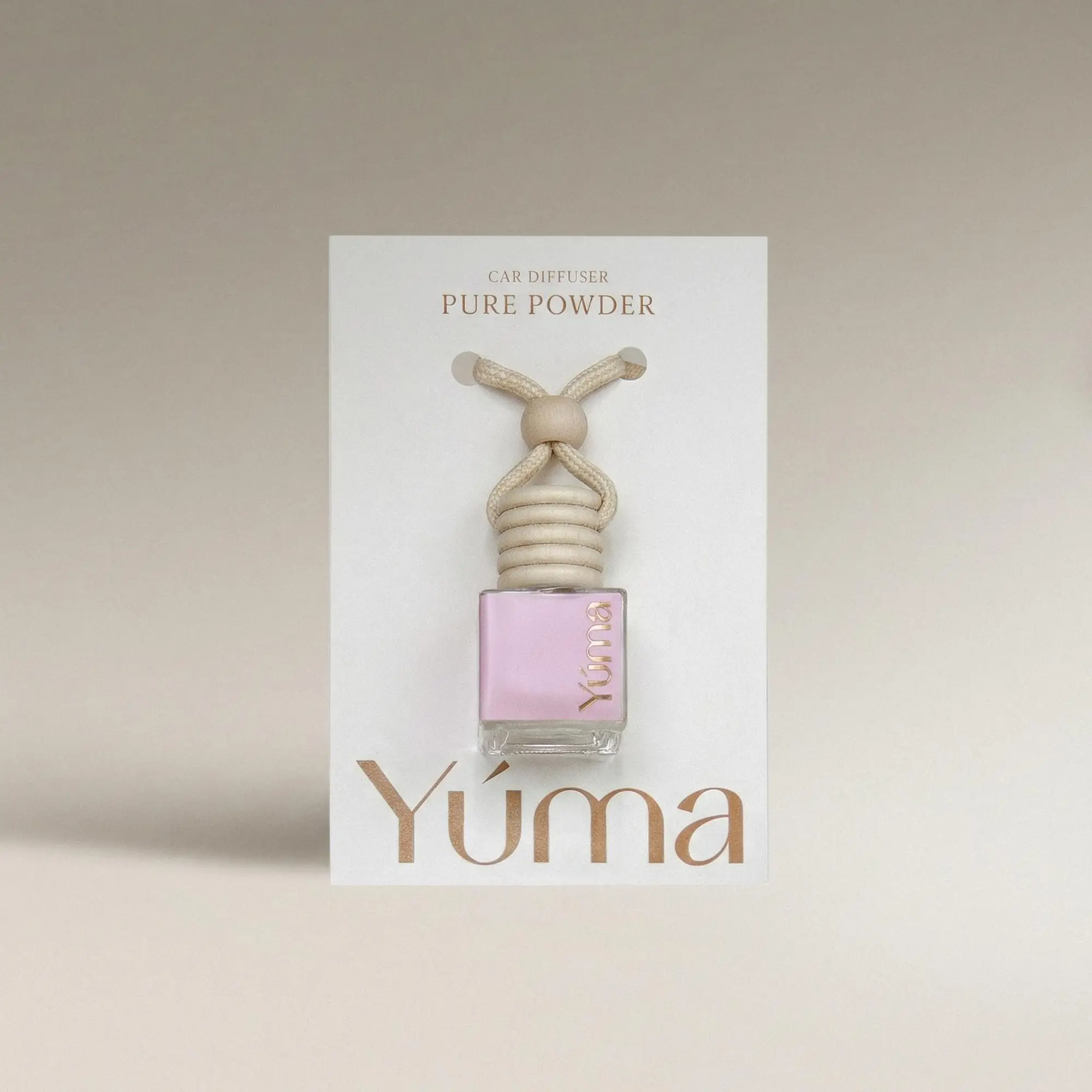 YUMA Pure Powder Car Diffuser in a glass bottle with a wooden cap and cord.