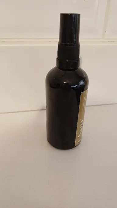 Black YUMA room spray bottle in the Gold Orchid scent on a white background.