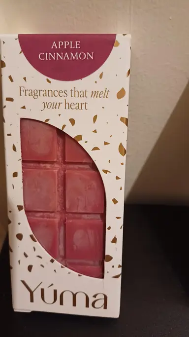 YUMA Apple Cinnamon packaging with red chocolate-shaped wax melts and gold details.