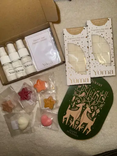 YUMA products including three small sprays, two wax bars, and star-shaped multicoloured wax melts.