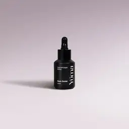 YUMA Black Orchid Car Diffuser Refill black bottle with dropper on a lilac background.