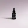 YUMA Black Orchid Car Diffuser Refill black bottle with dropper on a lilac background.
