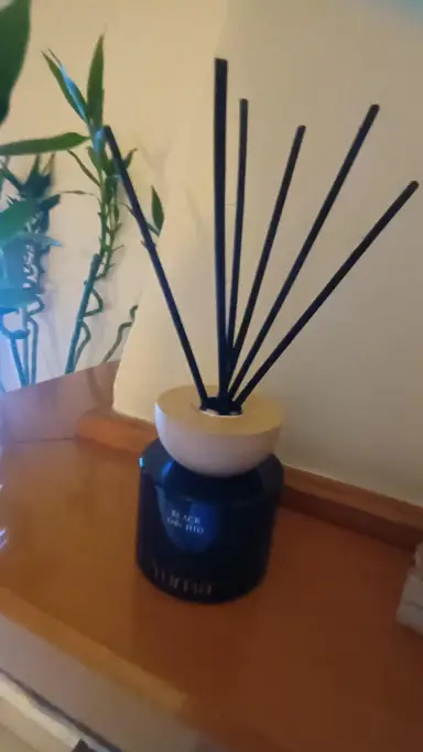 YUMA Black Orchid reed diffuser with black reeds and a wooden cap.