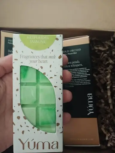 A green YUMA Hesperides Jasmine wax melt bar inside a white windowed box.