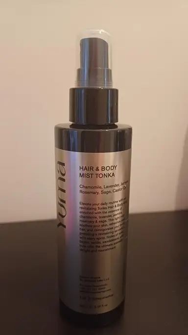 YUMA Tonka Hair and Body Mist in a cylindrical bottle with a spray pump.