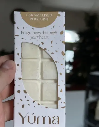 A white YUMA Caramelised Popcorn wax melt bar in paper packaging with gold detailing.
