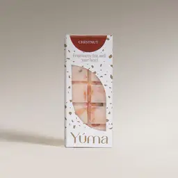 YUMA Chestnut wax melts in white packaging with an opening that reveals the embossed wax bar.