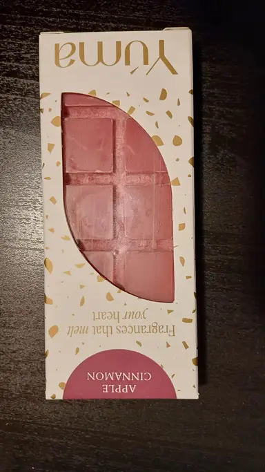 Pink chocolate-shaped wax melt inside a white YUMA box with gold details.
