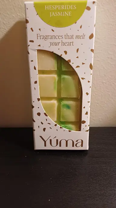 White YUMA Hesperides Jasmine packaging with a chocolate-shaped wax melt in green and yellow tones.