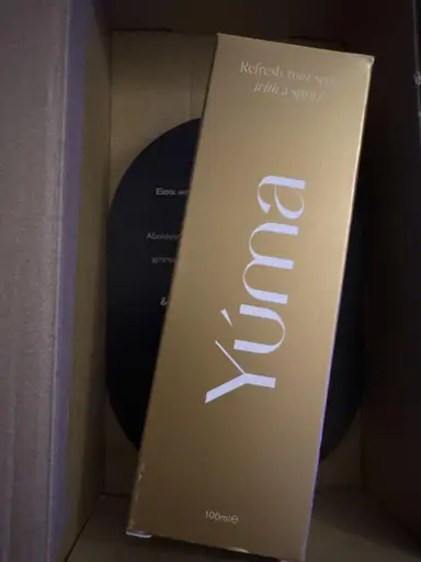 Gold rectangular YUMA box with white lettering, shown inside a cardboard shipping box.