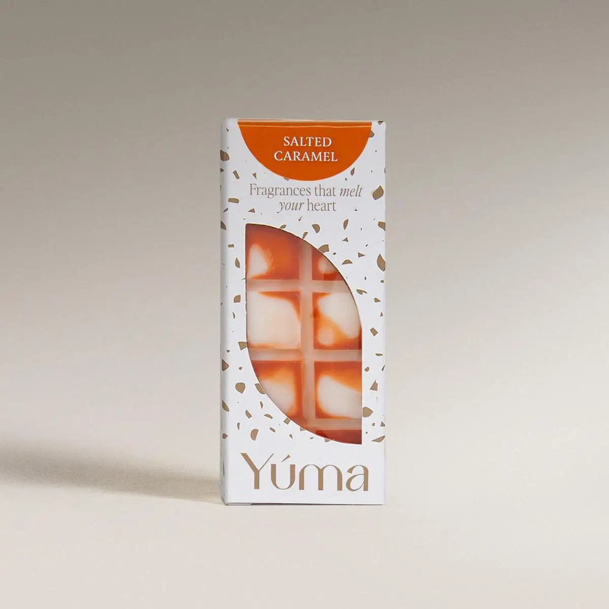 YUMA Salted Caramel wax melts in white packaging with orange detailing, on a neutral background.