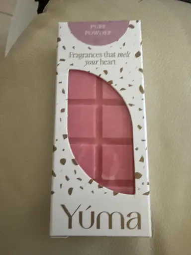 Pink YUMA wax melt in white packaging with gold detailing.