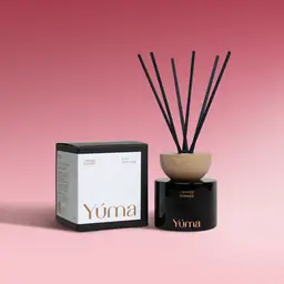 YUMA Cherry Sonnet black glass reed diffuser with a wooden cap and its box on a pink background.