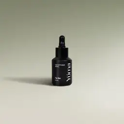 YUMA Fig Sap black glass bottle with dropper on a light background.