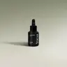 YUMA Fig Sap black glass bottle with dropper on a light background.