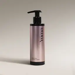 YUMA Cotton Candy Body Milk in a metallic pink bottle with a black pump on a beige background.