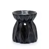 Black ceramic oil and wax melt burner in a pouch shape with embossed fold detailing.