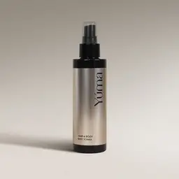 YUMA Tonka Hair & Body Mist in a metallic bottle with a black spray cap.