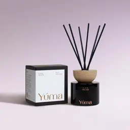 YUMA Black Orchid reed diffuser in a black glass bottle next to its paper packaging.