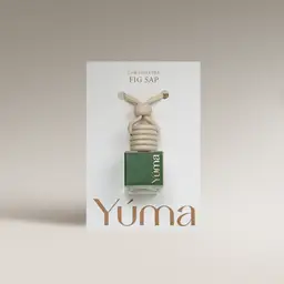 YUMA Fig Sap Car Diffuser in a green glass bottle with a wooden cap, shown in white packaging.