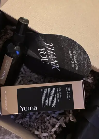 A YUMA Fresh Linen spray bottle and its packaging inside a box.