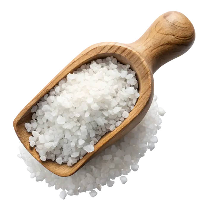 A wooden spoon filled with coarse white salt crystals on a white background.