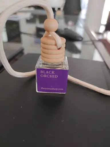 Small YUMA Black Orchid glass car diffuser with a wooden cap and white hanging rope.