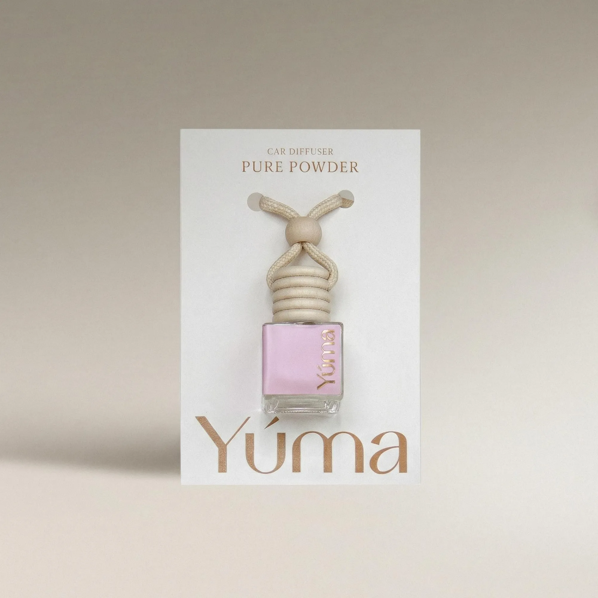 YUMA Pure Powder Car Diffuser in a glass bottle with a wooden cap and cord.
