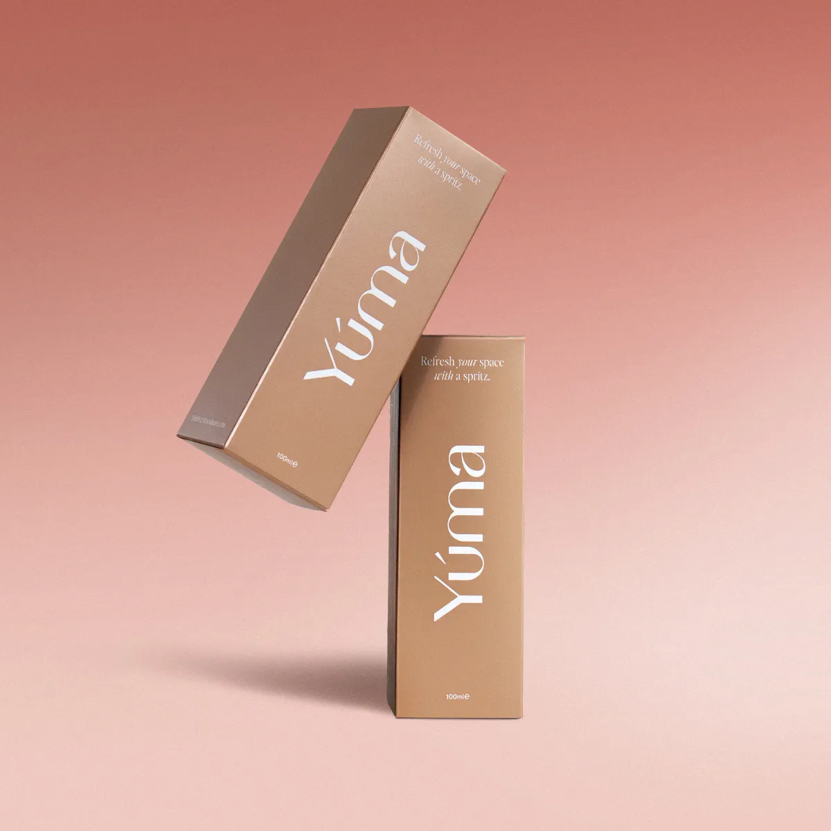 Two brown YUMA Melomakarono fabric fragrance sachets on a pink background.
