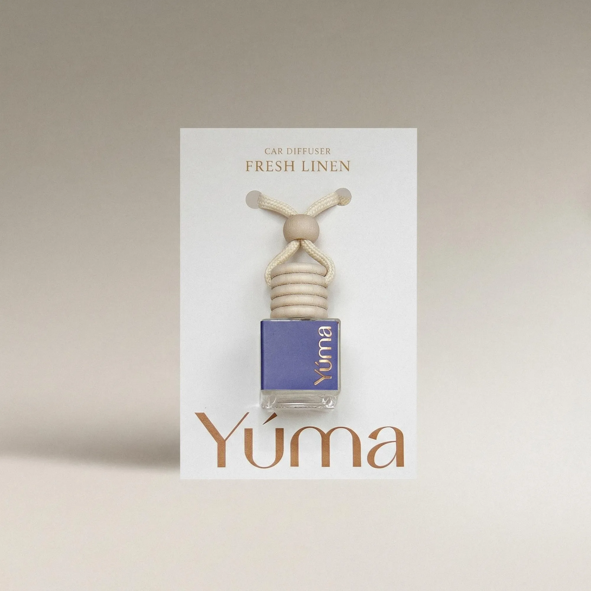 YUMA Fresh Linen Car Diffuser in a glass bottle with a wooden cap and cord.