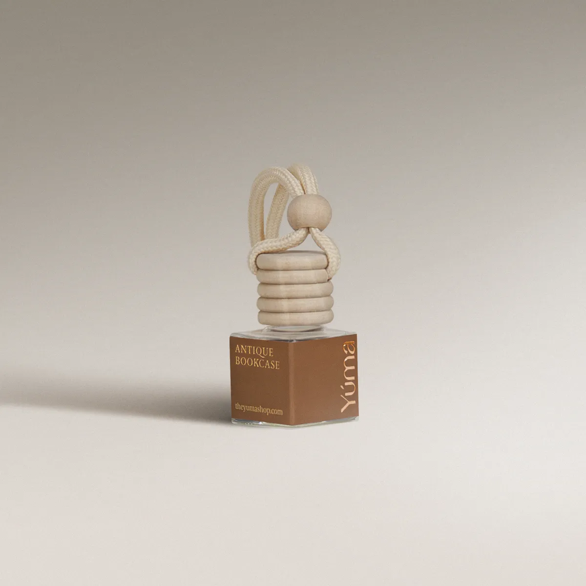 YUMA Antique Bookcase glass car diffuser with a wooden cap and beige cord.