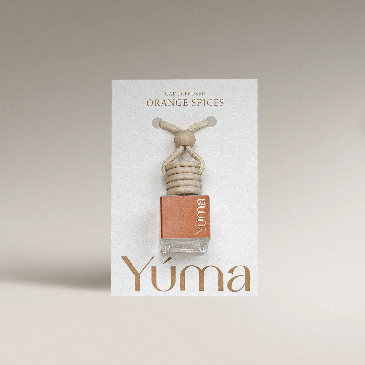 YUMA Orange Spices Car Diffuser in a glass bottle with a wooden cap and cord.