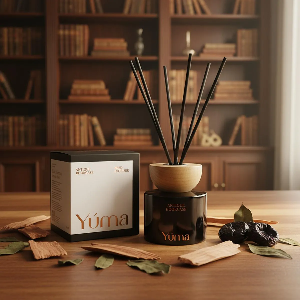 YUMA Antique Bookcase reed diffuser with black reeds next to its packaging on a wooden table.