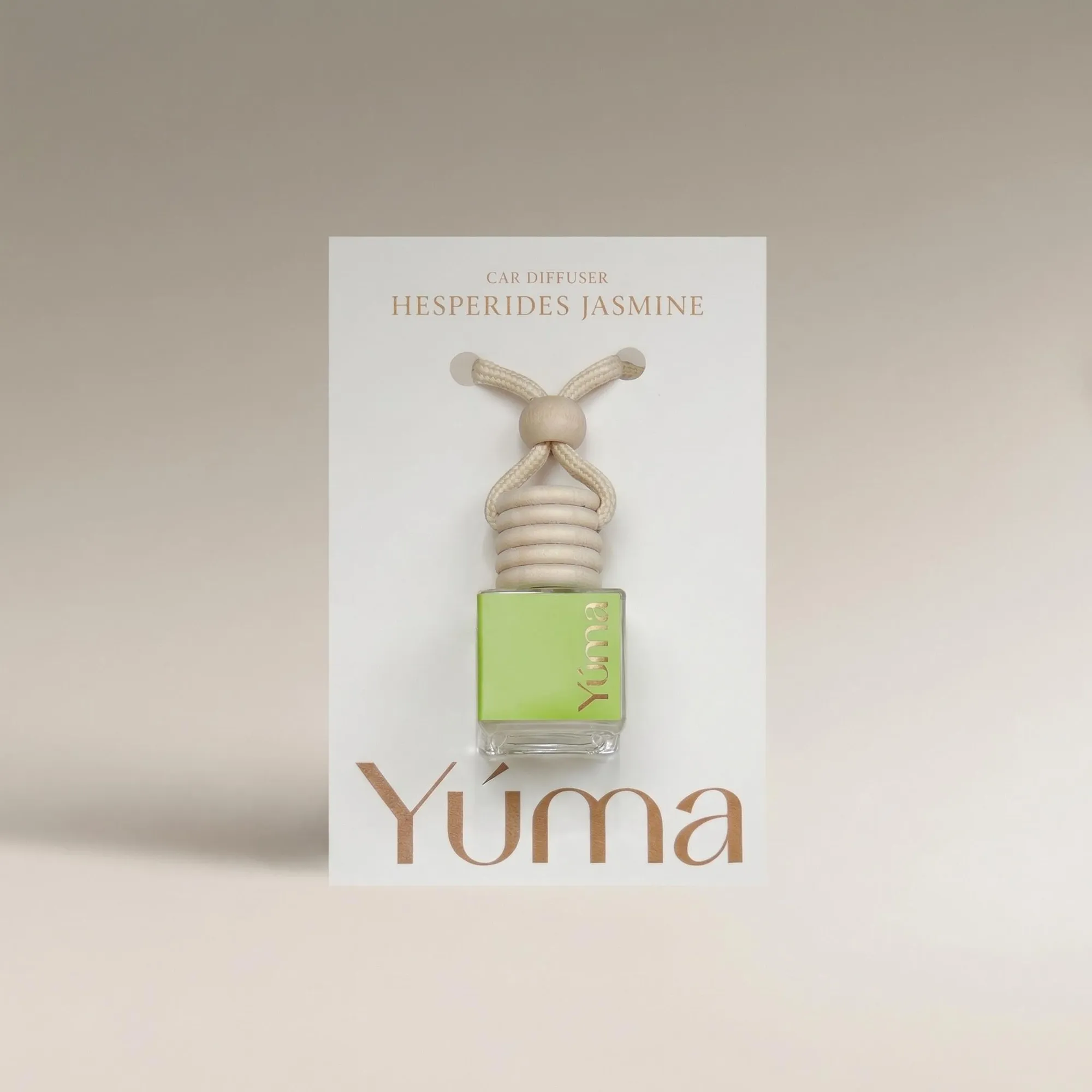 YUMA Hesperides Jasmine Car Diffuser in a glass bottle with a wooden cap and cord.