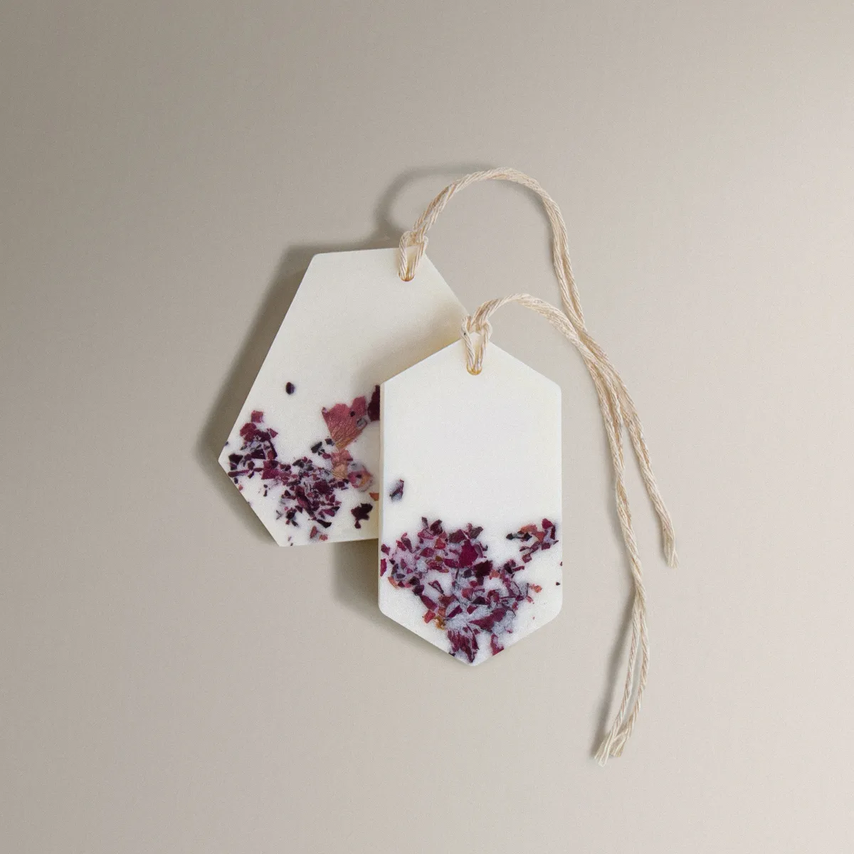 Two white Pure Powder Wax Tablets with dried rose petals and twine.