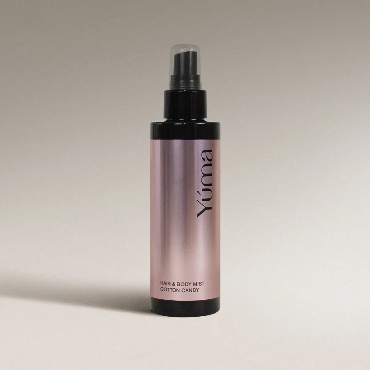 YUMA Cotton Candy Hair & Body Mist in a metallic pink bottle with a black cap.