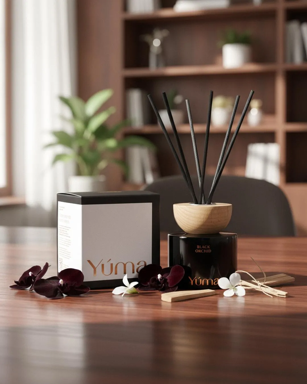YUMA Black Orchid reed diffuser with black reeds and dark orchid blooms on a wooden table.