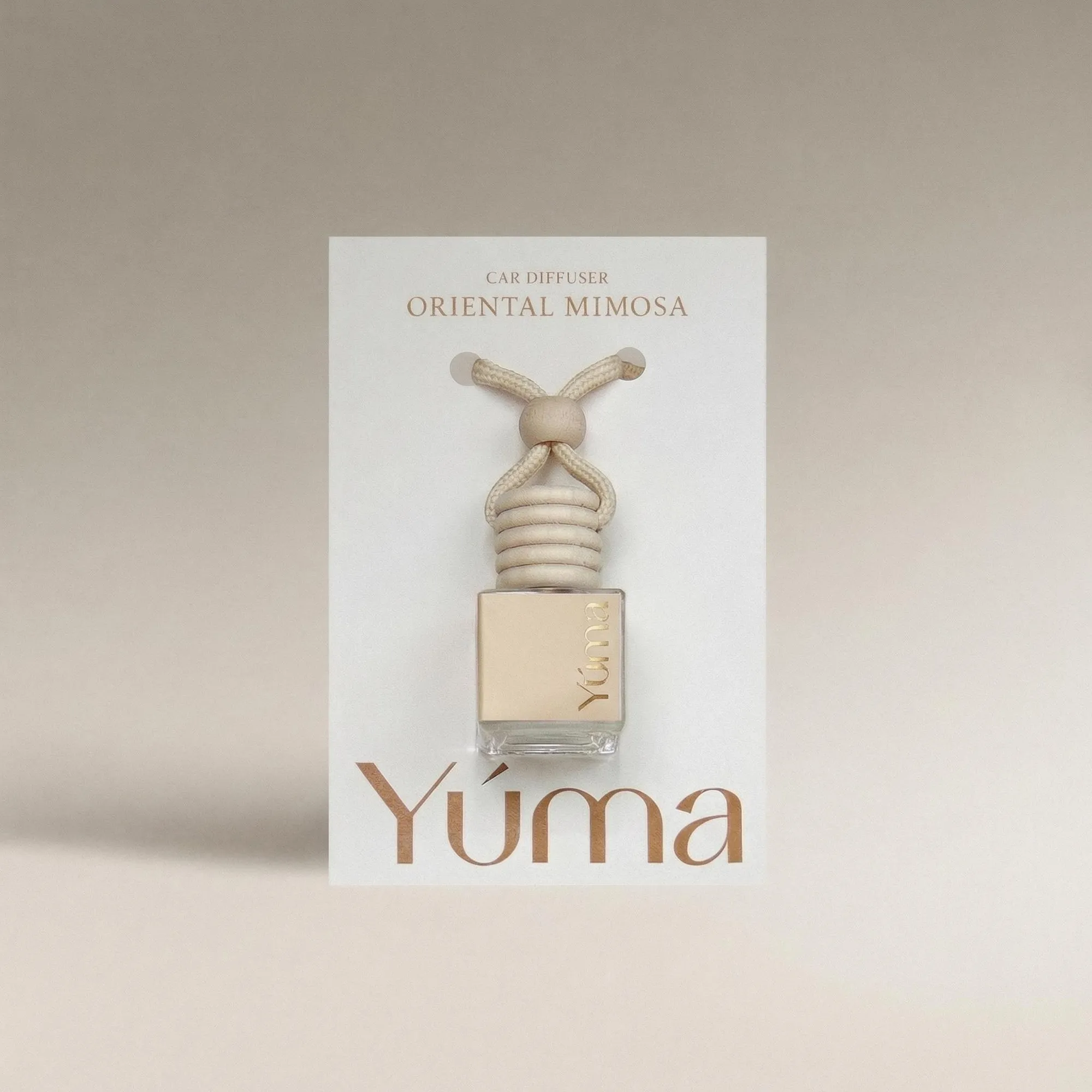 YUMA Oriental Mimosa Car Diffuser in a glass bottle with a wooden cap.