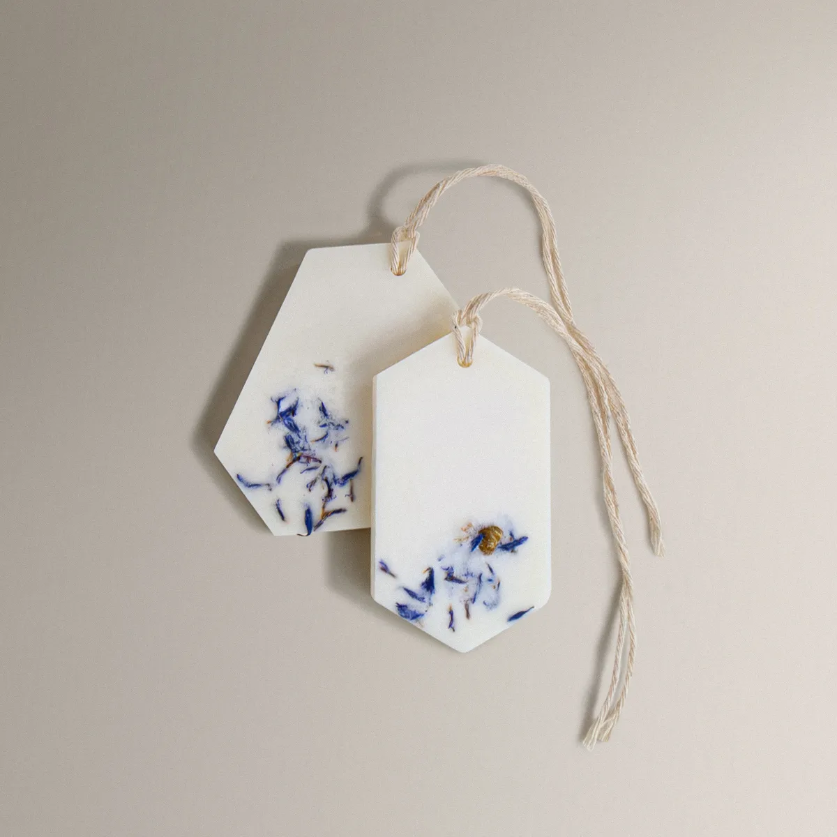 Two white Fresh Linen Wax Tablets with dried blue flowers and twine.