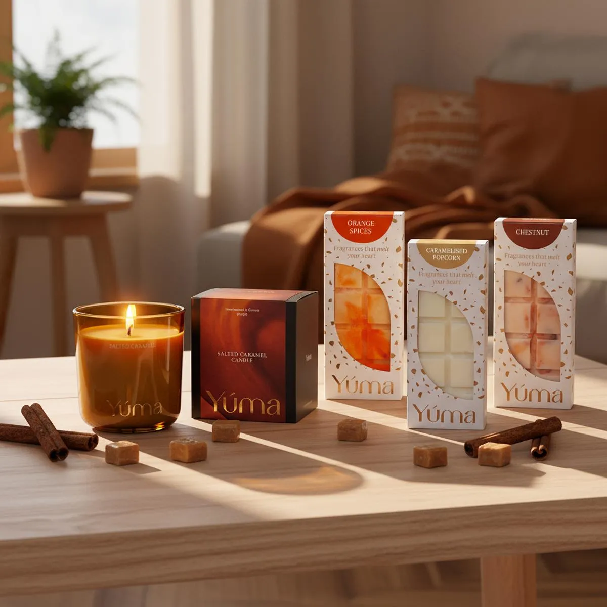 A lit Salted Caramel candle and three packs of YUMA wax melts on a wooden table with cinnamon sticks.