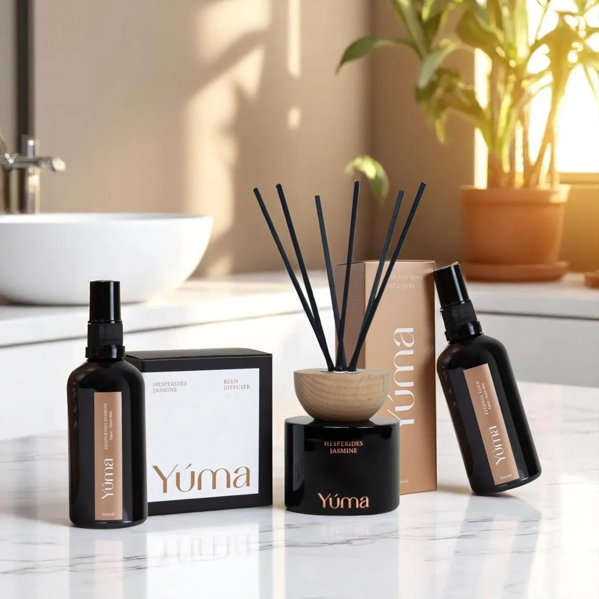 YUMA Hesperides Jasmine reed diffuser and two room sprays on a marble bathroom countertop.