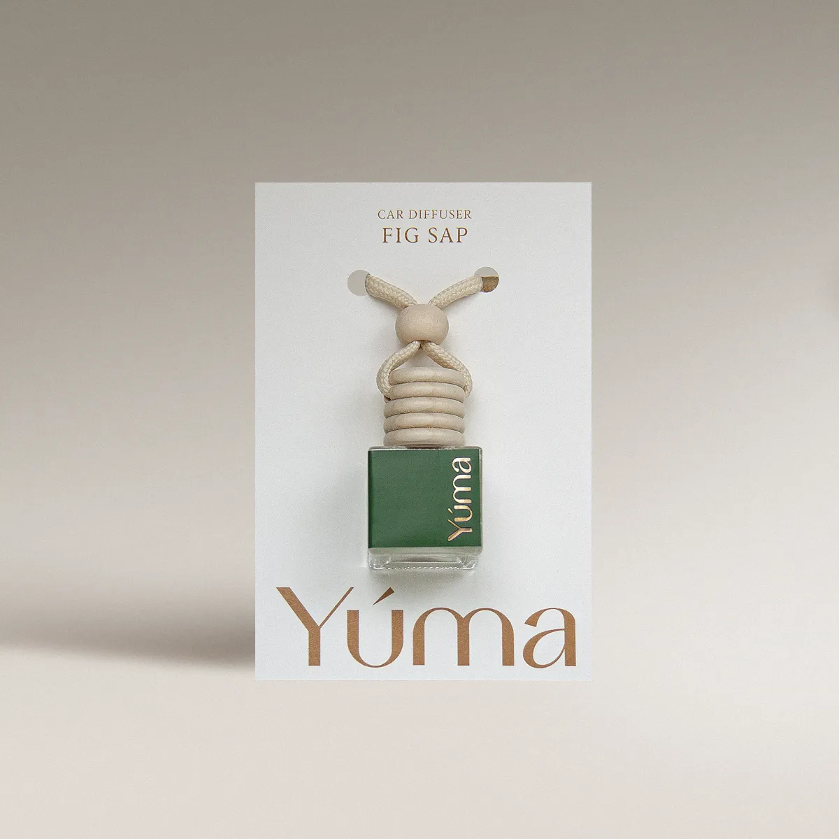 YUMA Fig Sap Car Diffuser in a green glass bottle with a wooden cap, shown in white packaging.