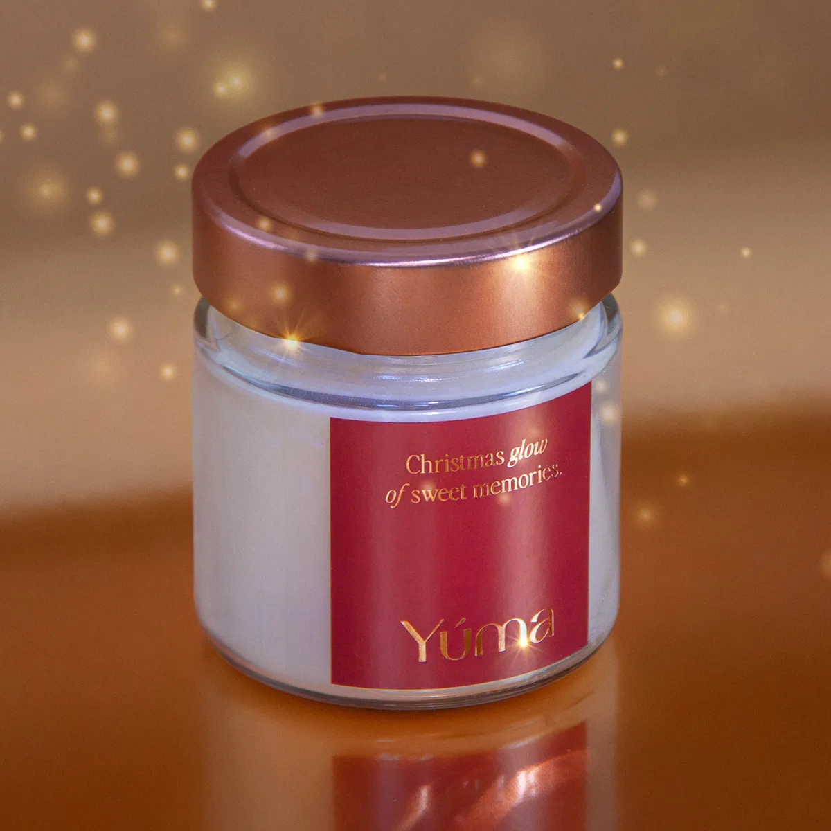 YUMA Melomakarono candle in a glass vessel with a copper-toned lid and red label.