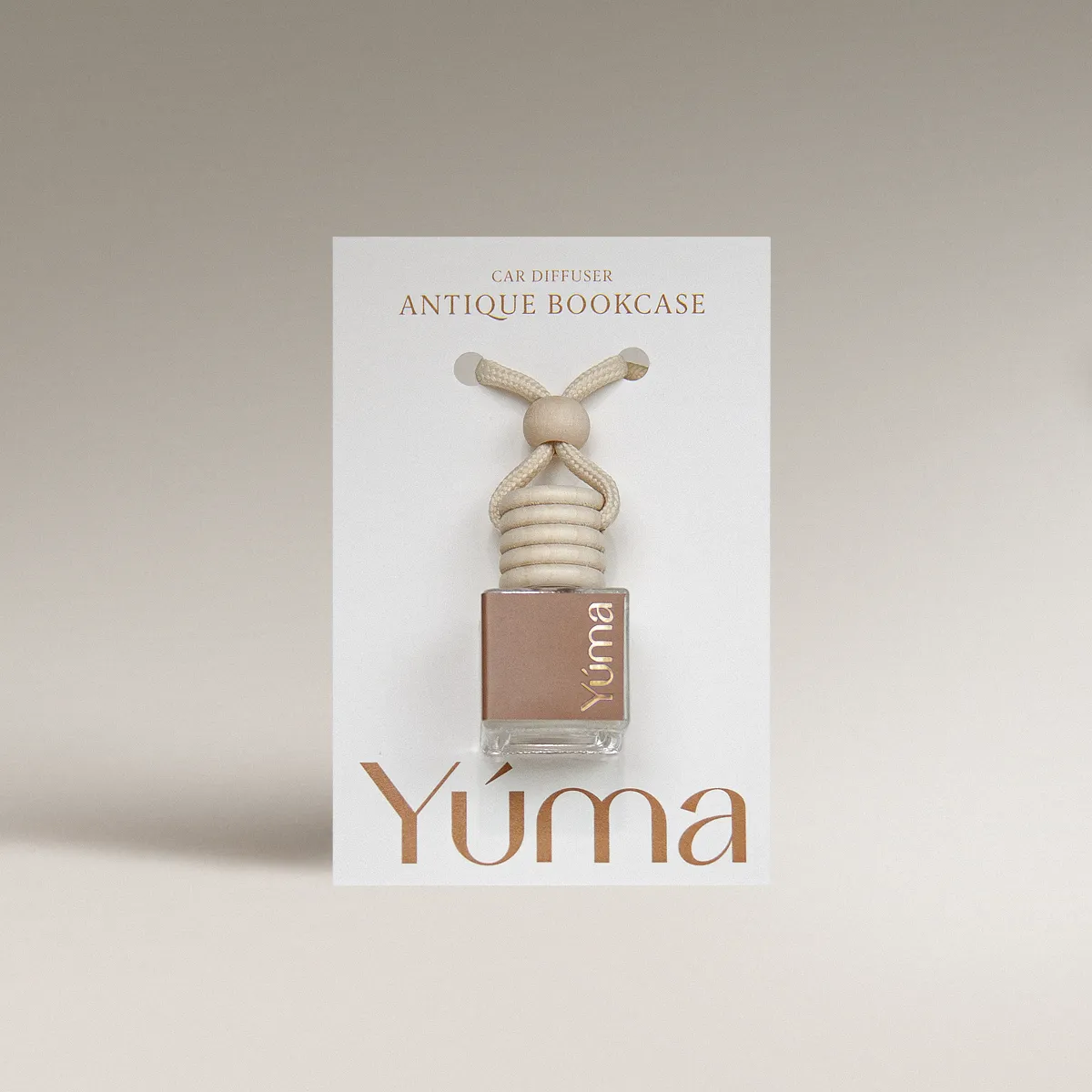 YUMA Antique Bookcase Car Diffuser in a glass bottle with a wooden cap and beige rope, shown in white packaging.