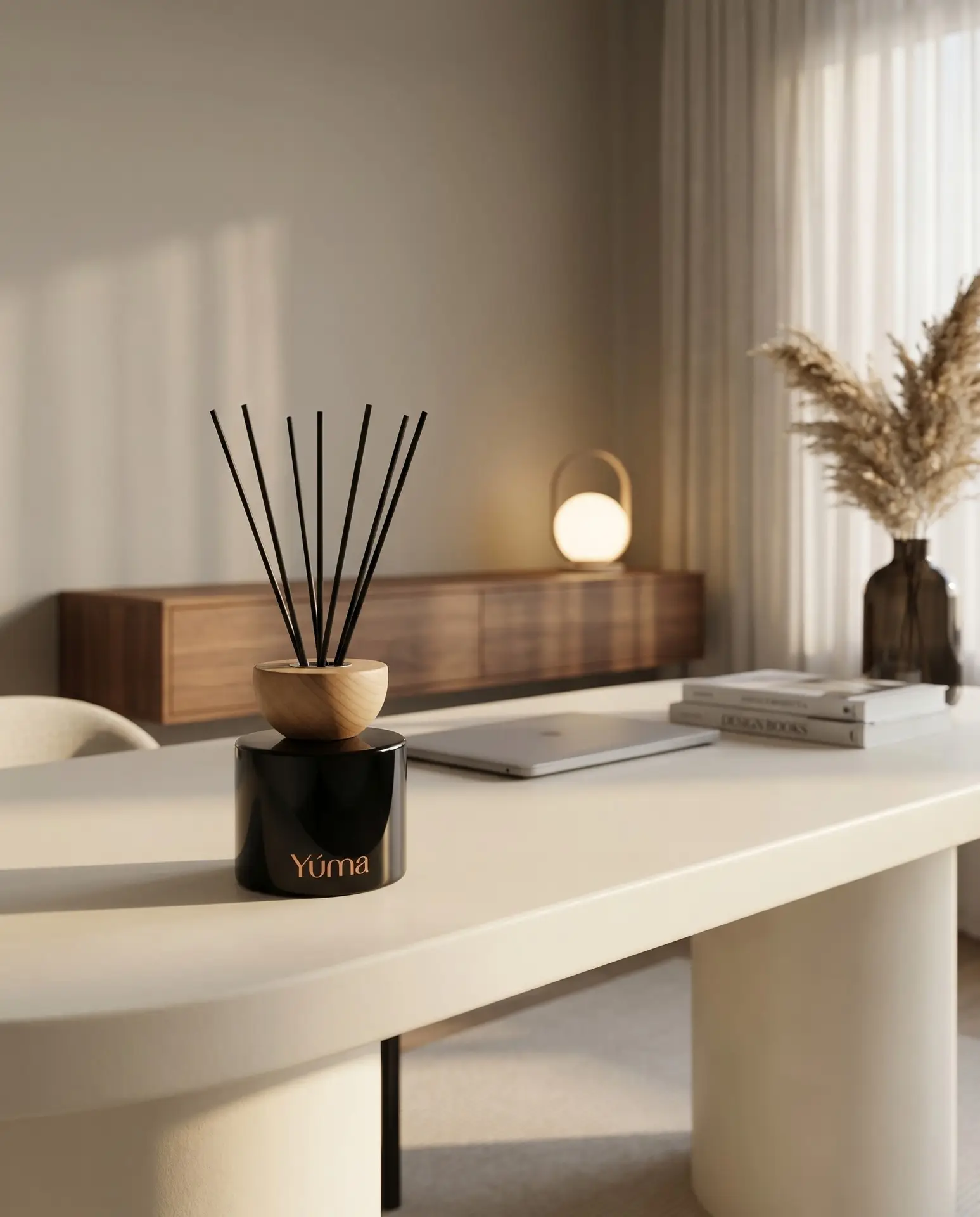 YUMA reed diffuser with black reeds in a bright contemporary room. YUMA reed diffuser with black reeds in a bright contemporary room.