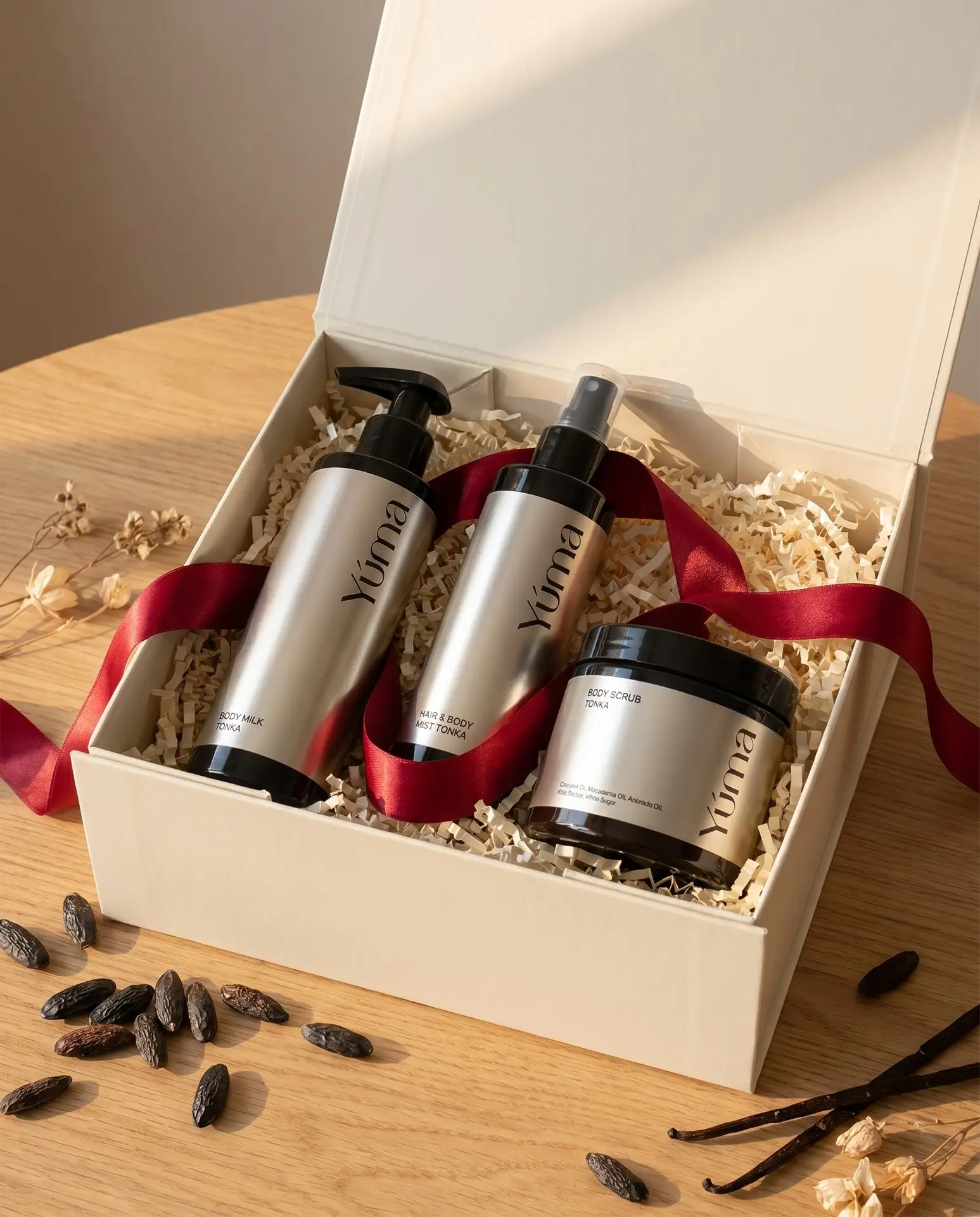 YUMA Tonka Body Milk, Hair and Body Mist, and Body Scrub in an open gift box. YUMA Tonka Body Milk, Hair and Body Mist, and Body Scrub in an open gift box.