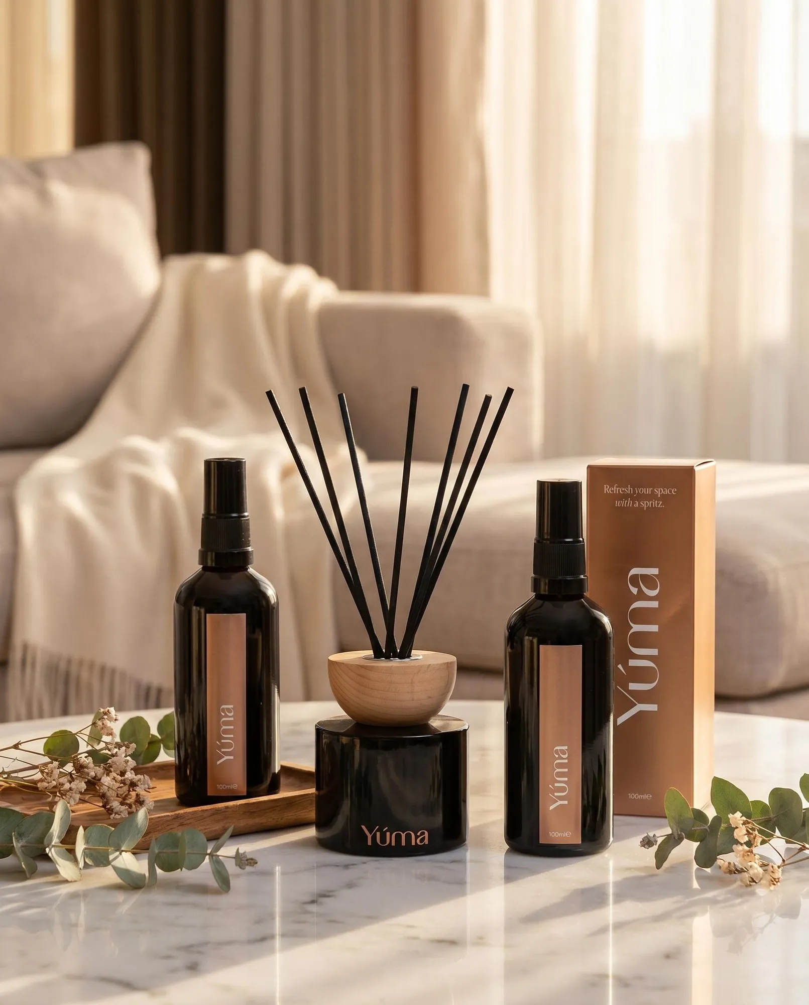 Anti Tobacco Room Set Two YUMA room sprays and a reed diffuser in black bottles on a marble surface.