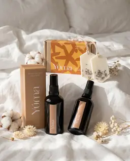 Linen Set YUMA Fresh Linen and Pure Powder Fabric/Room Mists with Gold Orchid Wax Tablets and gift box on white bed linen.