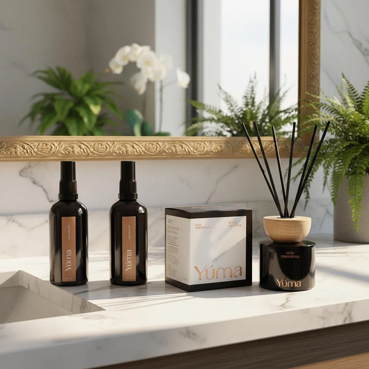 Bathroom Set Two YUMA room sprays, a box, and a reed diffuser arranged on a marble bathroom countertop.